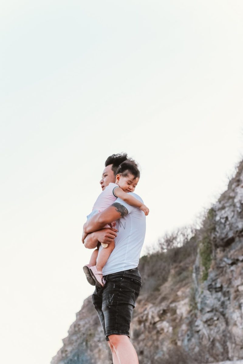 single father holding adopted baby