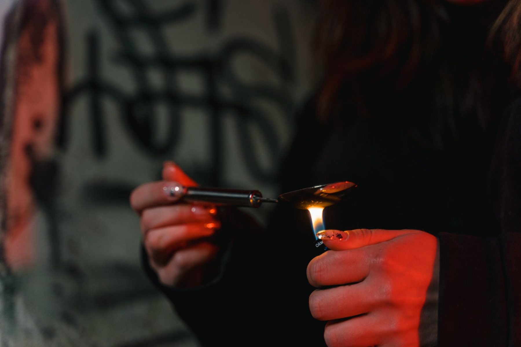 woman preparing heroin in a spoon